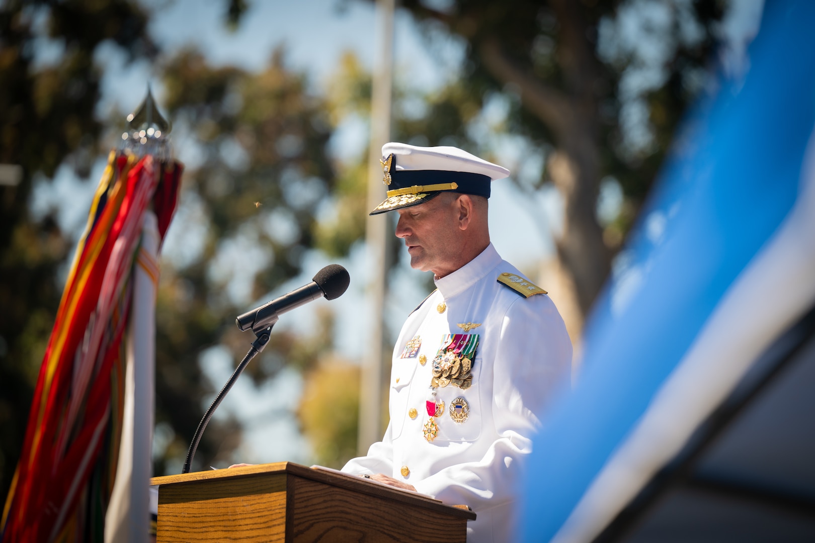 U.S. Coast Guard Rear Adm. Joseph Buzzella delivers an address during a change-of-command ceremony in Alameda, Calif., July 8, 2025.