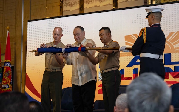From left to right, U.S. Marine Corps Lt. Gen. James Glynn, commander, U.S. Marine Corps Forces, Pacific, Philippines Secretary of National Defense Gilberto Teodoro Jr., and the 37th Commandant of the Philippine Marine Corps, Maj. Gen. Vicente Blanco, unfurl a flag during the opening ceremony of the 11th iteration of the Pacific Amphibious Leaders Symposium, Manila, Philippines, July 8, 2025. Bringing together experts and leaders from across the Indo-Pacific, PALS fosters collaboration among Allied and partner amphibious and maritime forces to share knowledge and recent operational insights. This year’s symposium hosted senior leaders from 22 participating nations who are committed to a free and open Indo-Pacific, with the objective of strengthening and developing regional relationships. (U.S. Marine Corps photo by Lance Cpl. Moses S. Lopez Franco)