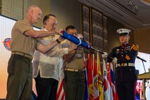 U.S. Marine Corps Lt. Gen. James Glynn, left, commander, U.S. Marine Corps Forces, Pacific, Philippines Secretary of National Defense Gilberto Teodoro Jr., middle, and the 37th Commandant of the Philippine Marine Corps, Maj. Gen. Vicente Blanco, unfurls the Pacific Amphibious Leaders Symposium 2025 flag during the opening ceremony of the 11th iteration of PALS, Manila, Philippines, July 8, 2025. Bringing together experts and leaders from across the Indo-Pacific, PALS fosters collaboration among Allied and partner amphibious and maritime forces to share knowledge and recent operational insights. This year’s symposium hosted senior leaders from 22 participating nations who are committed to a free and open Indo-Pacific, with the objective of strengthening and developing regional relationships. (U.S. Marine Corps photo by Lance Cpl. Roger-Junior Annoh)