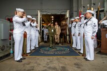 Armed Forces of the Philippines (AFP) Brig. Gen. Daniel D. Tansip, right, Chief of the AFP Chaplain Service, salutes sideboys following a tour aboard Nimitz-class aircraft carrier USS George Washington (CVN 73) while anchored off the coast of the Philippines, July 5, 2025.