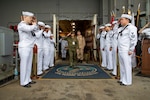 Armed Forces of the Philippines (AFP) Brig. Gen. Daniel D. Tansip, right, Chief of the AFP Chaplain Service, salutes sideboys following a tour aboard Nimitz-class aircraft carrier USS George Washington (CVN 73) while anchored off the coast of the Philippines, July 5, 2025.