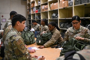 Airmen from the 97th Air Mobility Wing participate in a mass deployment line exercise at Altus Air Force Base, Oklahoma, June 5, 2025. The exercise tested the Wing’s ability to mobilize personnel and equipment in support of global operations rapidly. (U.S. Air Force photo by Airman 1st Class Lauren Torres)