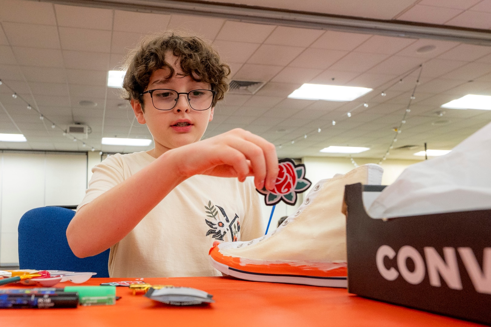 Aiden Blake customizes a pair of shoes during Operation Sole at JBSA-Fort Sam Houston, Texas, June 14.