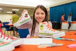 April North poses with her customized shoes during Operation Sole at JBSA-Fort Sam Houston, Texas, June 14.