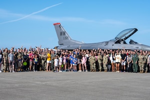 U.S. Air Force Col. Matthew Kenkel, 35th Fighter Wing deputy commander, poses for a group photo with his final, or fini, flight celebration attendees.