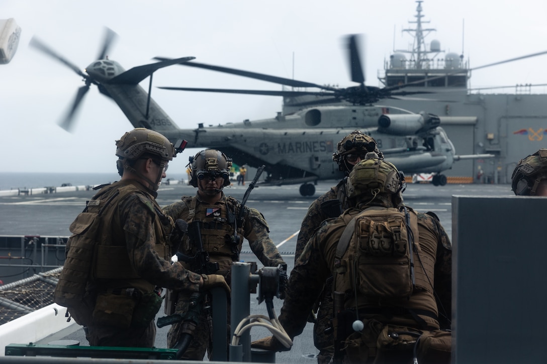 U.S. Marines with Maritime Raid Force, 31st Marine Expeditionary Unit, prepare to depart during a visit, board, search and seizure exercise aboard the expeditionary sea base John L. Canley (ESB-6), in the Coral Sea, July 7, 2025. VBSS is part of the maritime interception operations that aim to delay, disrupt, or destroy enemy forces or supplies in the maritime domain. The 31st MEU is operating aboard ships of the USS America Amphibious Ready Group in the 7th Fleet area of operations, the U.S. Navy’s largest forward-deployed numbered fleet, and routinely interacts and operates with allies and partners in preserving a free and open Indo-Pacific region. (U.S. Marine Corps photo by Cpl. Alora Finigan)