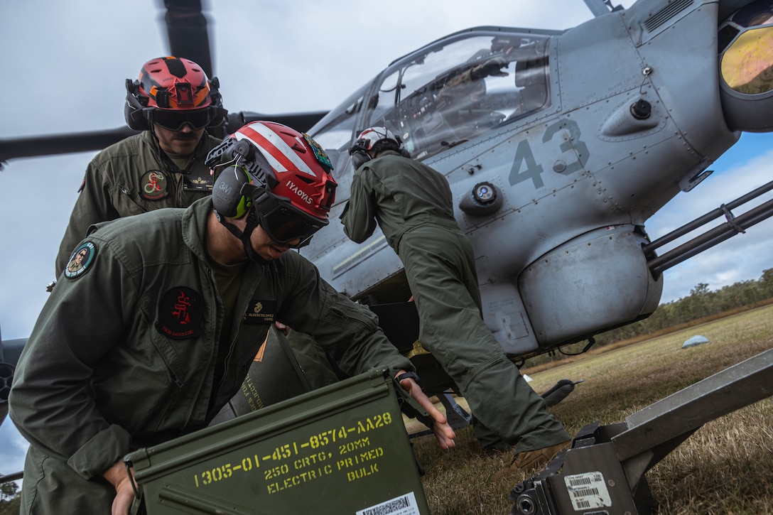 U.S. Marines with Marine Medium Tiltrotor Squadron (VMM) 265 (Rein.), 31st Marine Expeditionary Unit, load 20mm caliber ammunition into an AH-1Z Viper assigned to VMM-265 (Rein.) during a forward arming and refueling point exercise at Glen Airfield, Queensland, Australia, July 7, 2025. Marines loaded ordnance rapidly and tactically to exercise arming aircraft in a high-pressure environment, such as a FARP and sustain technical and tactical proficiency. The 31st MEU is operating aboard the ships of the USS America Amphibious Ready Group in the 7th Fleet area of operations, the U.S. Navy’s largest forward deployed numbered fleet, and routinely interacts and operates with allies and partners in preserving a free and open Indo-Pacific region. (U.S. Marine Corps photo by Lance Cpl. Victor Gurrola)