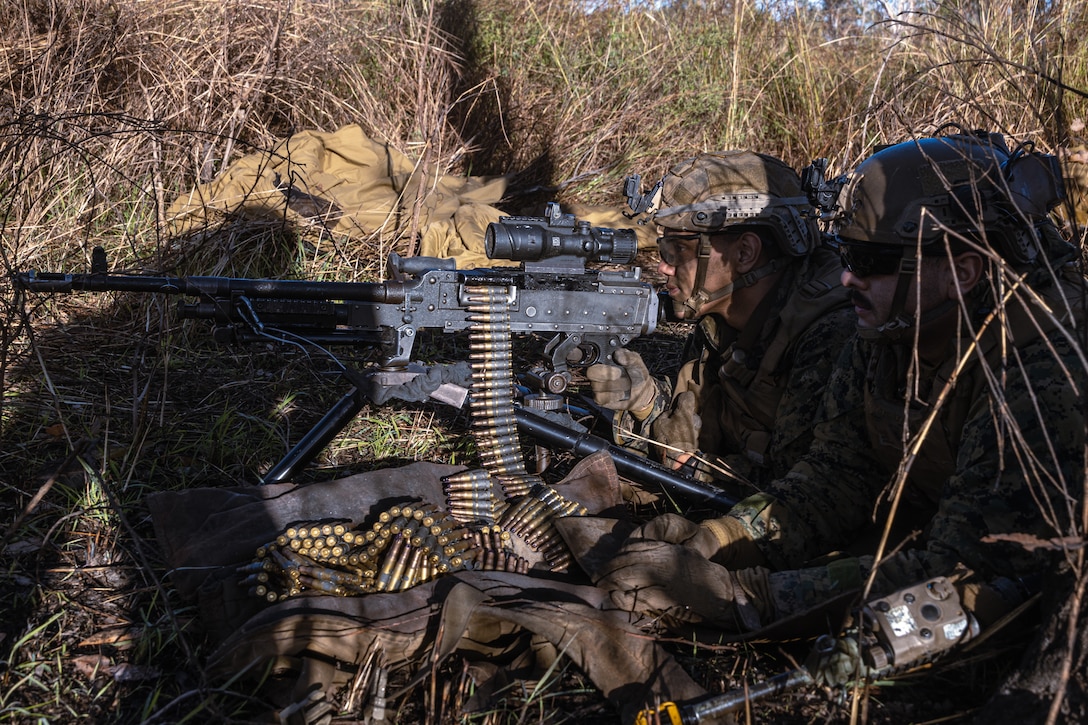 U.S. Marine Corps Lance Cpl. Justin Mercado-Henriquez, left, and Cpl. Jose Nunez both machine gunners with Animal Company, Battalion Landing Team 1st Battalion, 7th Marine Regiment, 31st Marine Expeditionary Unit, set security with an M240B on the defensive line during a simulated assault and seizure at Glen Airfield, Queensland, Australia, July 2-7, 2025. Marines capture and control objectives to enable future MEU operations such as a forward arming and refueling point on the airfield. The 31st MEU is operating aboard the ships of the USS America Amphibious Ready Group in the 7th Fleet area of operations, the U.S. Navy’s largest forward deployed numbered fleet, and routinely interacts and operates with allies and partners in preserving a free and open Indo-Pacific region. Mercado-Henriquez is a native of Puerto Rico and Nunez is a native of Texas. (U.S. Marine Corps photo by Lance Cpl. Victor Gurrola)