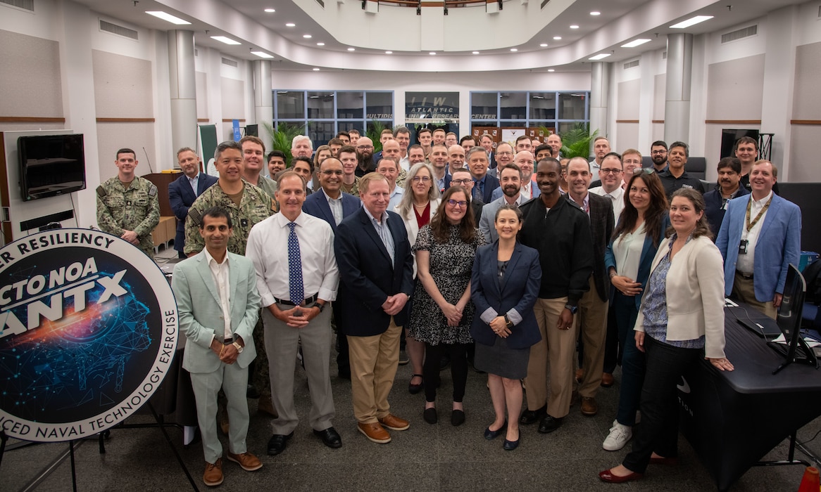 Photo of NIWC Pacific and Atlantic workforce at CyberANTX posing for a group photo in the atrium