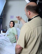 150417-N-ME988-015 NORTH CHICAGO, Ill. (April 17, 2015) Amy Leigh Abelson (left), cast in the role of a victim of sexual assault, listens to Kurt Uebersax (right), from KJU Productions LLC, during a Sexual Assault Forensic Examination (SAFE) scene rehearsal at the Captain James A. Lovell Federal Health Care Center. The scene is part of a Navy Sexual Assault Prevention and Response Office (DON SAPRO) educational training video that will be shown at the Senior Enlisted Academy (SEA) at the U.S. Naval War College. (U.S. Navy photo by Mass Communication Specialist 2nd Class Darren M. Moore/Released)