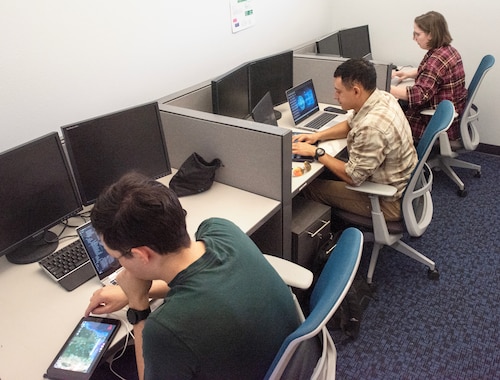 U.S. Air Force Airman 1st Class Daniel Gonzales, left, Staff Sgt. Desmond Wynter, center, and Staff Sgt. Charli Fiveash, all 805th Combat Training Squadron software developers, participate in an Operational Response Team Hackathon at Nellis Air Force Base, Nevada, June 5, 2025. The team developed an Android Tactical Assault Kit plugin to enhance pilot operations by streamlining the Find, Fix, Track, Target, Engage and Assess targeting process, improving coordination and decision-making across the force. (U.S. Air Force photo by Staff Sgt. Samantha Krolikowski)