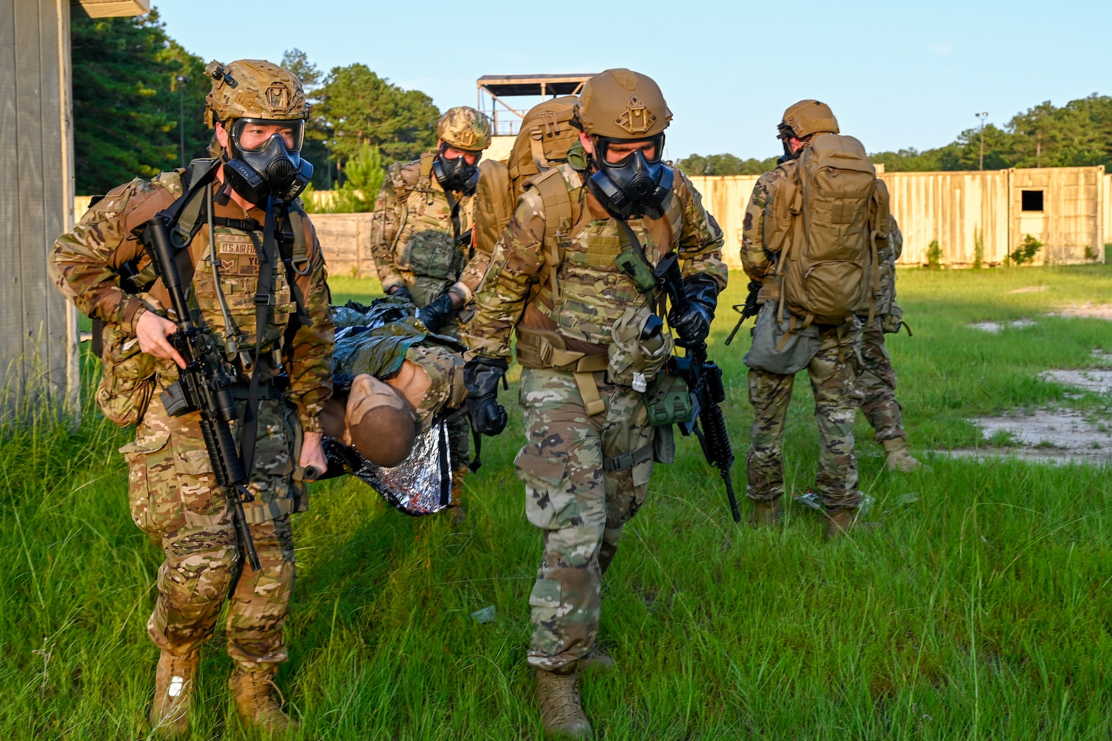 From left, U.S. Air Force Senior Airmen Matthew Yu and Josh Miller, assigned to 146 Airlift Wing and 123rd Airlift Wing, practice stretcher carrying during an emergency management battlefield expeditionary response deployment for training at McCrady Training Center, Eastover, South Carolina, June 26, 2025.