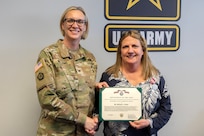 Col. Michelle M. Williams, U.S. Army Financial Management Command commander, presents Melissa L. Ooten, USAFMCOM assistant chief of staff (G1), with a Department of the Army superior civilian service medal at the Maj. Gen. Emmett J. Bean Federal Center in Indianapolis March 13, 2025. Ooten retired after more than 35 years of federal civil service. (U.S. Army photo by Mark R. W. Orders-Woempner)