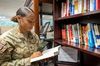 Capt. Jasmine Thompson, U.S. Army Financial Management Command aide de camp, reads a book at a new leadership library opened by USAFMCOM at the Maj. Gen. Emmett J. Bean Federal Center in Indianapolis July 7, 2025. The library was the brainchild of Kimberly Hood, USAFMCOM deputy chief of staff, meant to provide leadership resources for USAFMCOM military and civilian personnel. (U.S. Army photo by Mark R. W. Orders-Woempner)