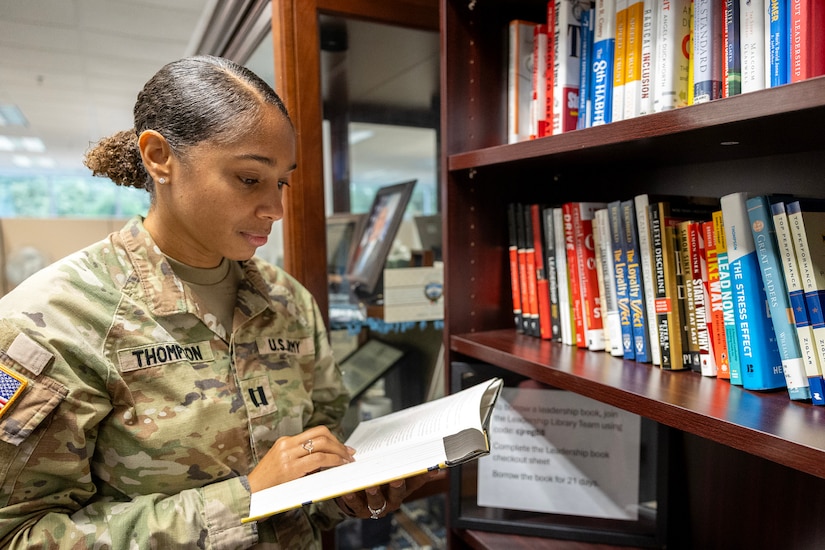 Capt. Jasmine Thompson, U.S. Army Financial Management Command aide de camp, reads a book at a new leadership library opened by USAFMCOM at the Maj. Gen. Emmett J. Bean Federal Center in Indianapolis July 7, 2025. The library was the brainchild of Kimberly Hood, USAFMCOM deputy chief of staff, meant to provide leadership resources for USAFMCOM military and civilian personnel. (U.S. Army photo by Mark R. W. Orders-Woempner)