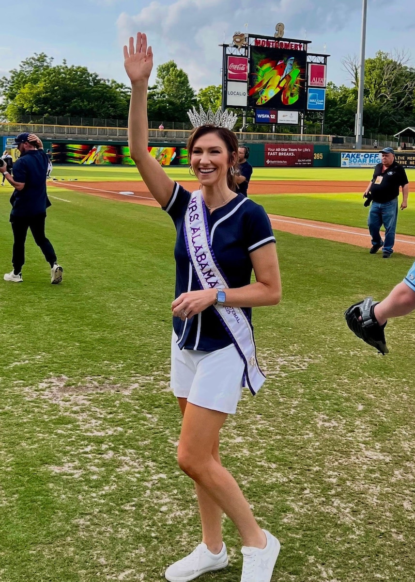 U.S. Air Force Capt. Melissa VanArtsdalen, Squadron Officer School instructor, crowned Mrs. Alabama International, waves to the crowd at a Montgomery Biscuits baseball game in Montgomery, Alabama, June 11, 2025