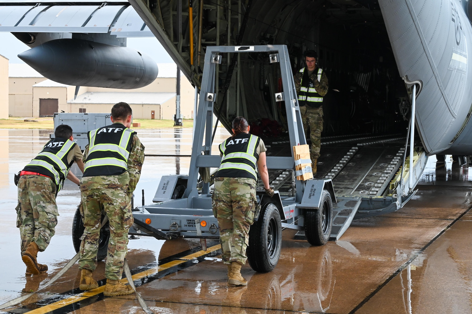 U.S. Air Force Airmen from the 7th Logistics Readiness Squadron load an engine trailer onto a C-130J Super Hercules during a Combat Readiness Inspection at Dyess AFB, Texas, July 1, 2025. The coordinated deployment and training exercise provided Airmen opportunities to move fast and think critically and creatively to maintain rapid deployment capabilities and mission readiness. (U.S. Air Force photo by Airman 1st Class Adrien Tran)