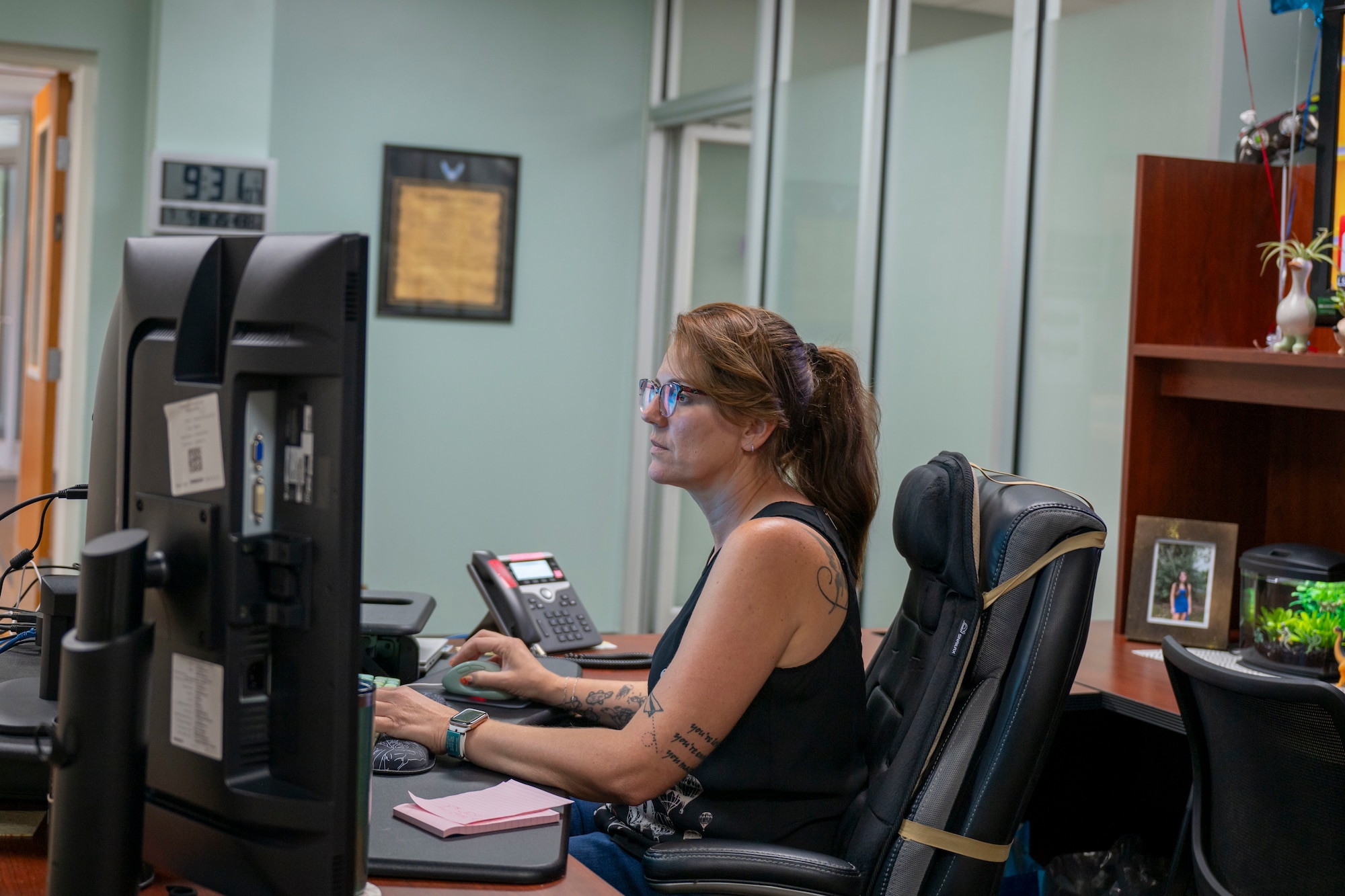 U.S. Air Force civilian Erin Lapeyrouse, executive assistant to senior leadership, works at her desk on July 9, 2025, at the I.G. Brown Training and Education Center, McGhee Tyson Air National Guard Base, Tennessee.  Erin is the recipient of the Chief on the National Guard Bureau Civilian of the Year award.