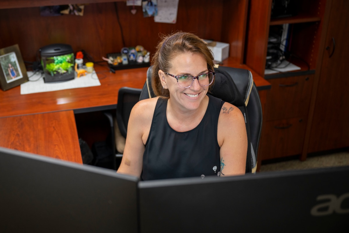 U.S. Air Force civilian Erin Lapeyrouse, executive assistant to senior leadership, works at her desk on July 9, 2025, at the I.G. Brown Training and Education Center, McGhee Tyson Air National Guard Base, Tennessee.  Erin is the recipient of the Chief on the National Guard Bureau Civilian of the Year award.