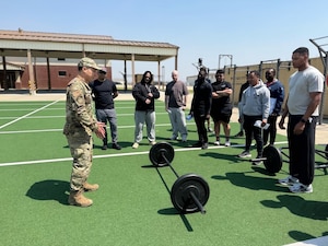 Image of an Airman training other people/