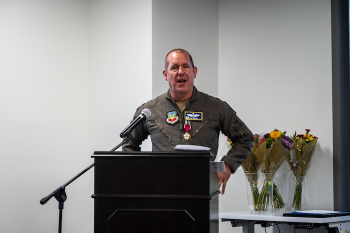 photo of US Airman standing in front of a podium speaking