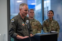 photo of US Airman standing in front of a podium speaking