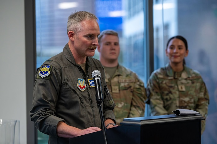 photo of US Airman standing in front of a podium speaking