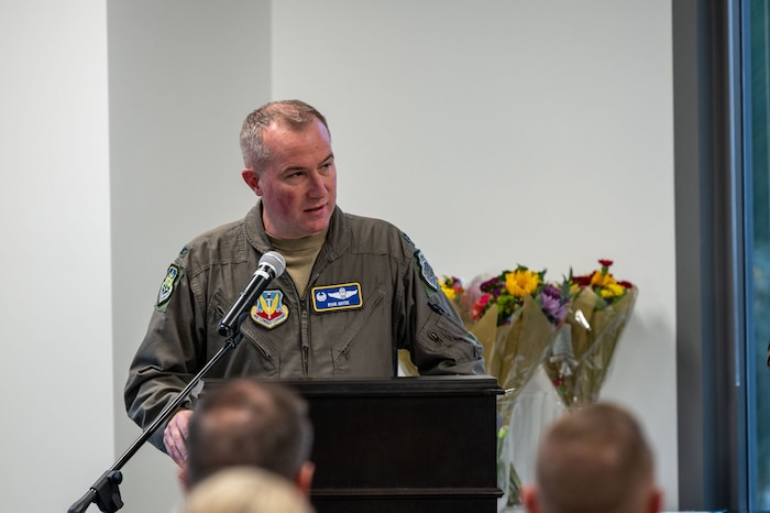 photo of US Airman standing in front of a podium speaking