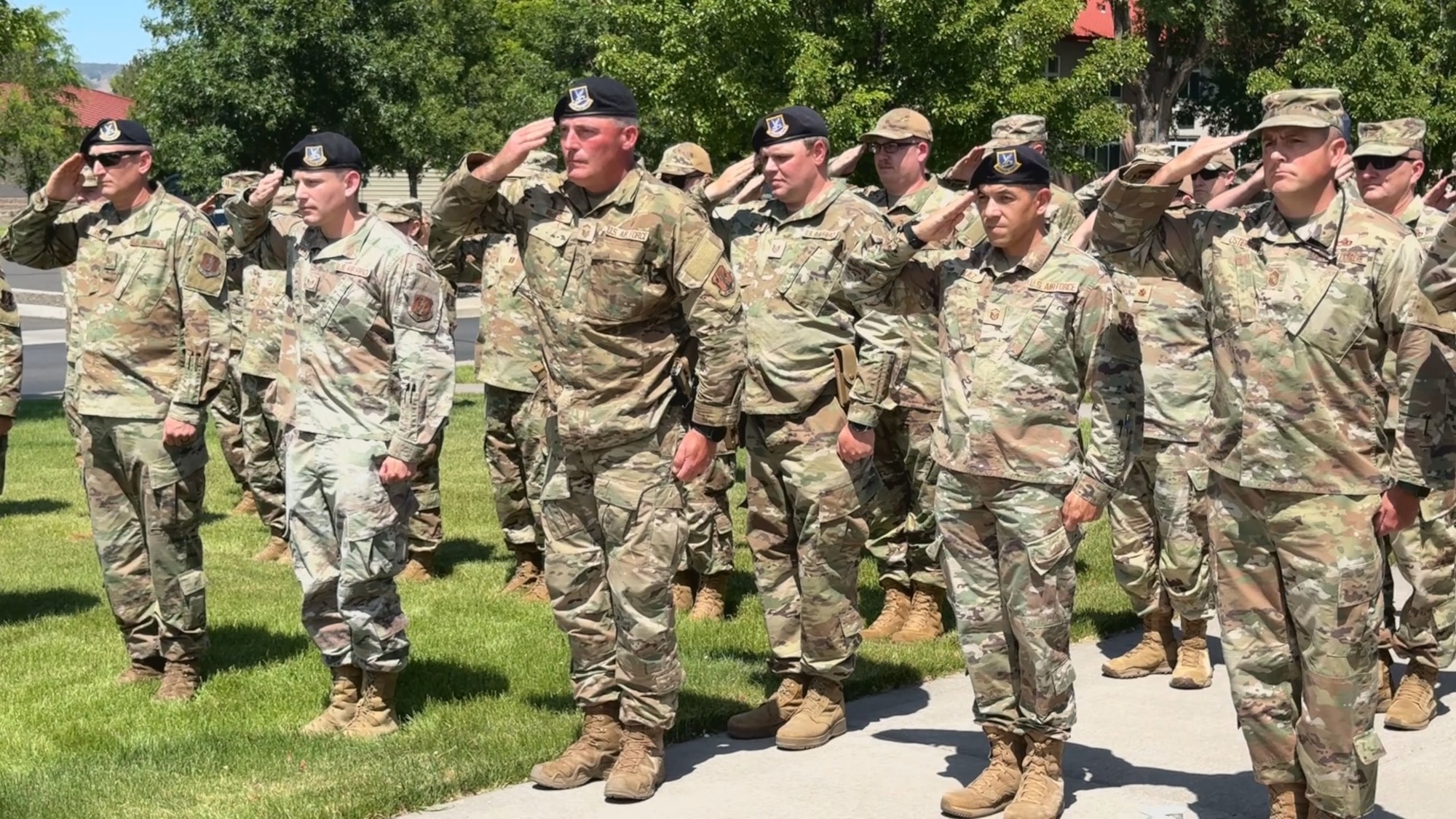 People in uniform salute