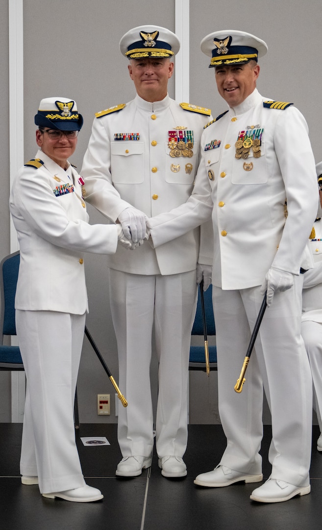 Rear Adm. Douglas Schofield, commander, Coast Guard Southeast District, Capt. Janet D. Espino-Young and Capt. Jason C. Aleksak, pose for a photo during a change of command ceremony at the Jacksonville Public Library in Jacksonville, Florida, July 9, 2025. Schofield presided over the ceremony in which Espino-Young transferred command of Sector Jacksonville to Aleksak. (U.S. Coast Guard photo by Petty Officer 3rd Class Kace White)