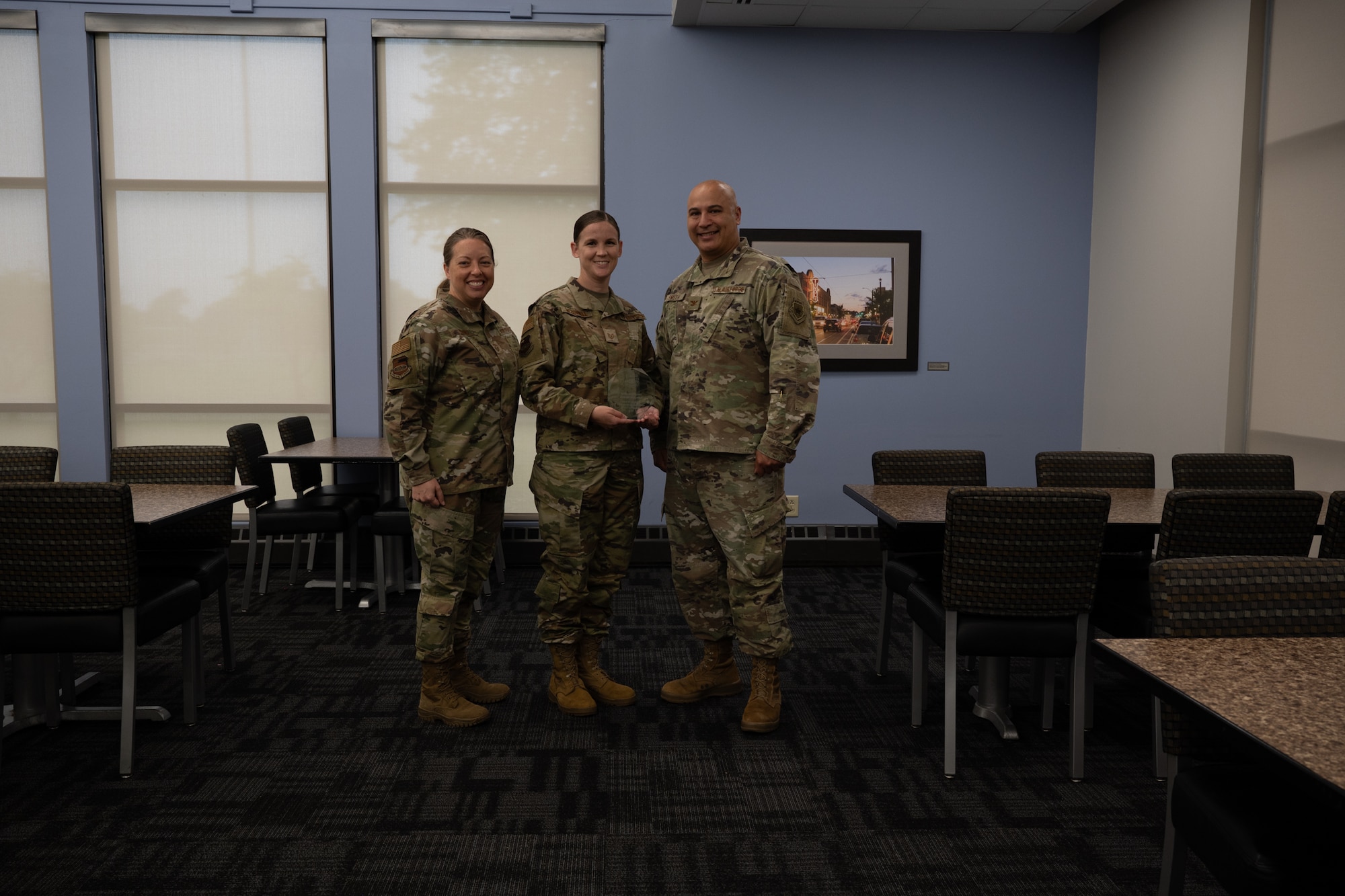 Tech. Sgt. Amanda McConnell holds her quarterly award given to her by Col. Jeffrey Smith and Chief Master Sgt. Andrea Young at Scott Air Force Base, Illinois, June 7, 2025. The winners were selected based on their technical expertise, demonstration of leadership and job performance during the period of January 2025 to March 2025.