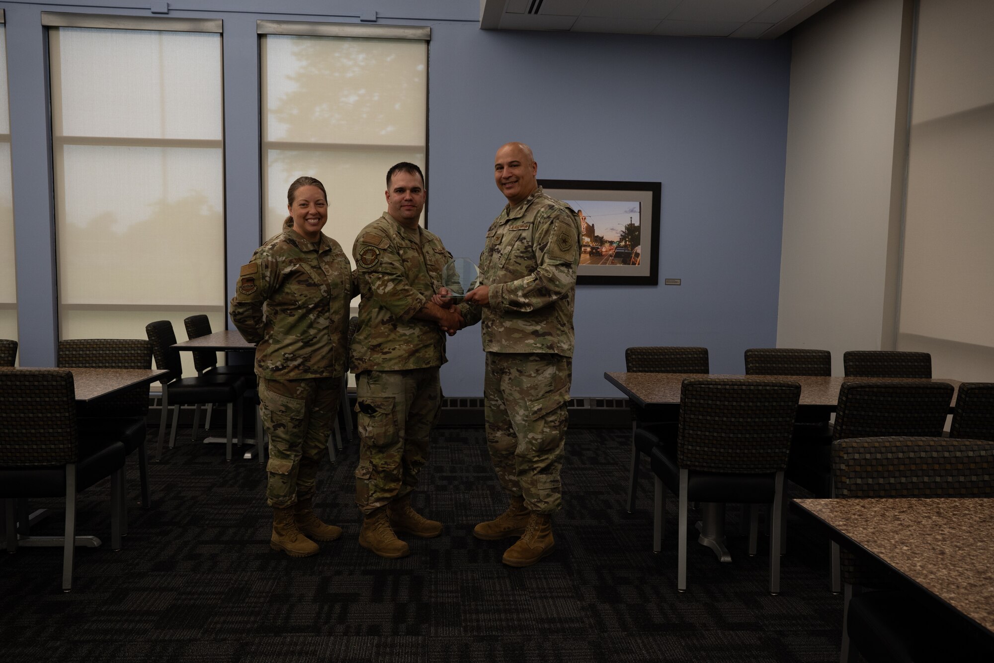 Master Sgt. Kenneth Van De Hay holds his quarterly award given to him by Col. Jeffrey Smith and Chief Master Sgt. Andrea Young at Scott Air Force Base, Illinois, June 7, 2025. The winners were selected based on their technical expertise, demonstration of leadership and job performance during the period of January 2025 to March 2025.