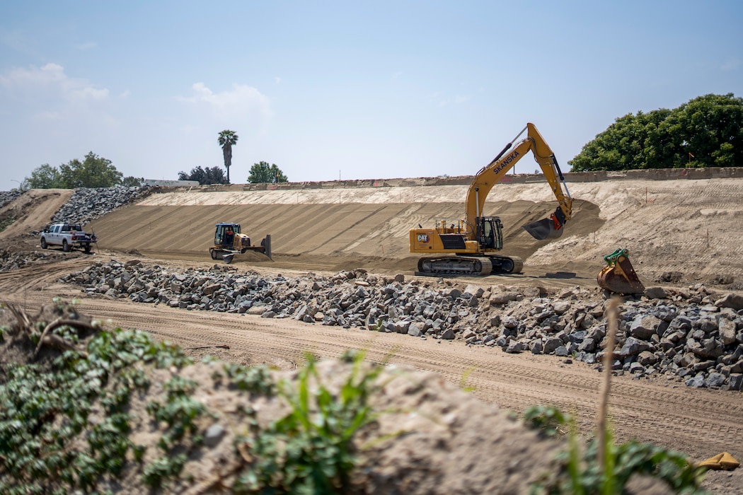 An excavator smooths bedding material May 1 on the slope of a levee in Riverside, California, where the U.S. Corps of Engineers Los Angeles District, Riverside County Flood Control and Water Conservation District and contractors have started work again for the levee rehabilitation project.