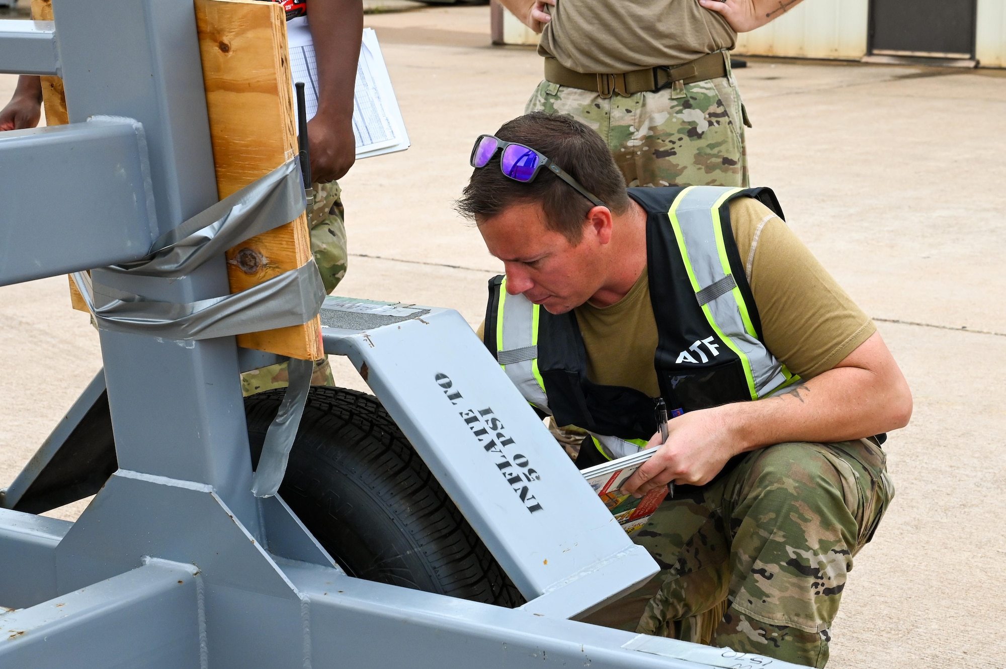 U.S. Air Force Tech. Sgt. Eric Hazlewood, 7th Logistics Readiness Squadron air transportation section chief, inspects a tire during the 317th Airlift Wing’s Combat Readiness Inspection at Dyess AFB, Texas, July 1, 2025. Air Mobility Command inspectors evaluated every step of the wing’s deployment operations. (U.S. Air Force photo by Airman 1st Class Adrien Tran)