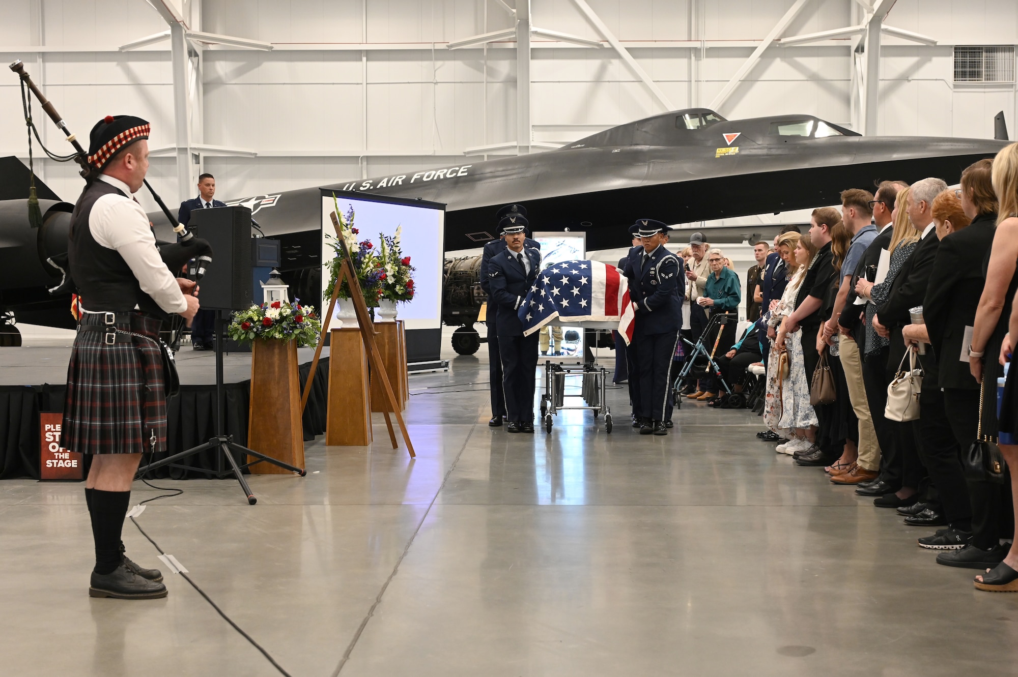 Honor guard members prepare to move a casket in front of family members and guests of the memorial service for Lt. Wilson.
