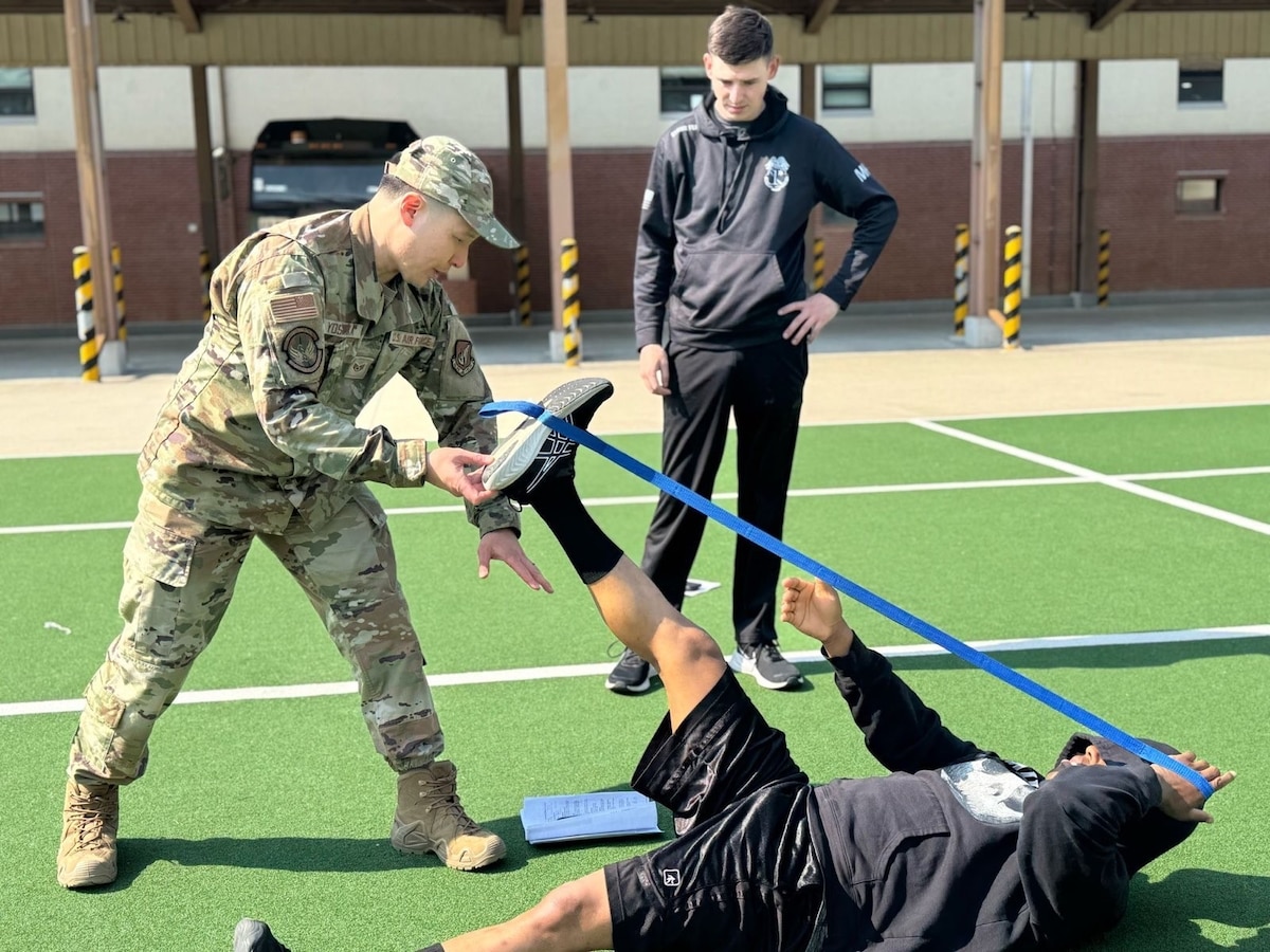 Image of an Airman training with another person.
