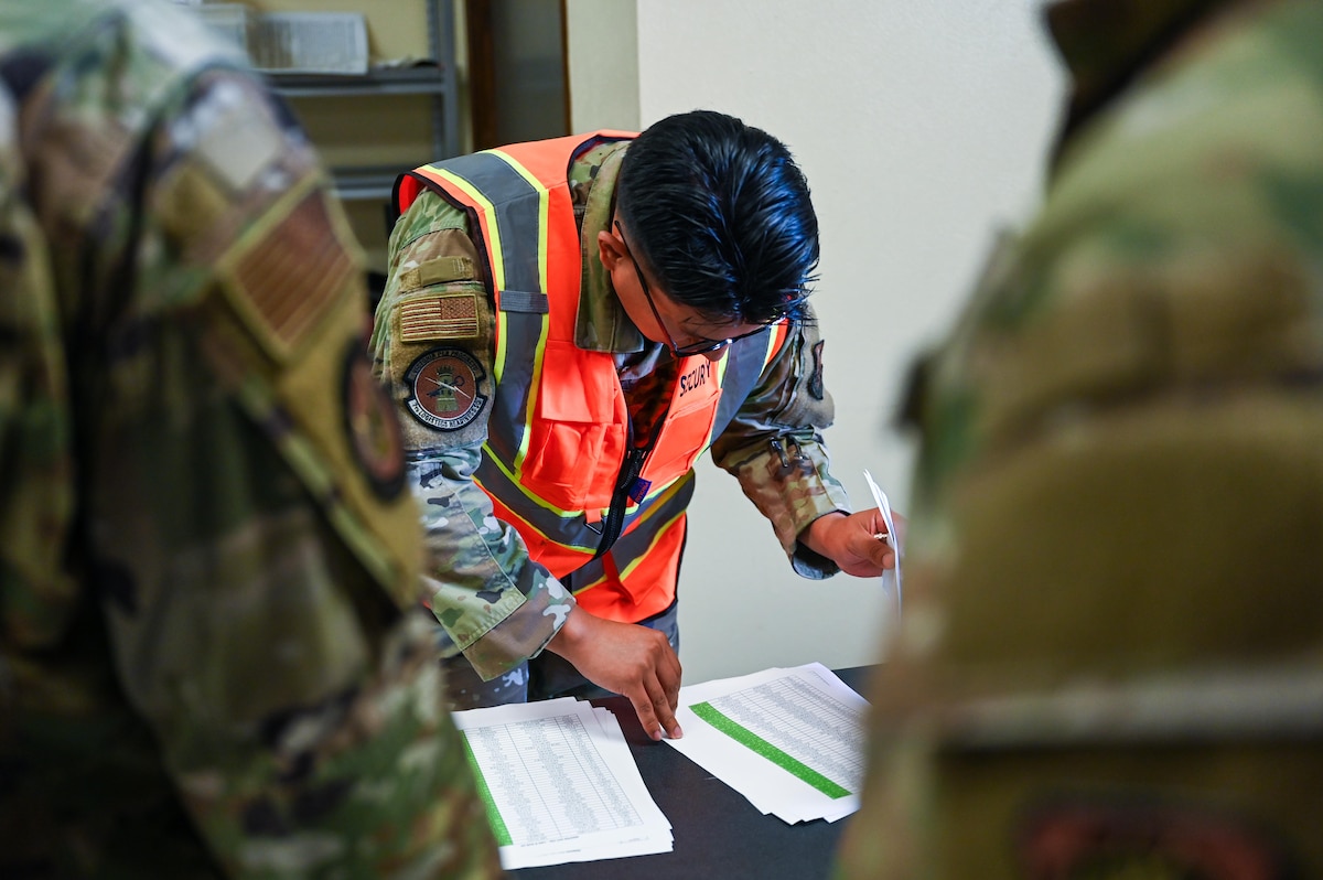 U.S. Air Force Airman 1st Class Christian Sanchez, 7th Logistics Readiness Squadron vehicle maintenance journeyman, checks an entry authorization list during a Combat Readiness Inspection at Dyess Air Force Base, Texas, July 1, 2025. The 317th Airlift Wing was evaluated by Air Mobility Command during its first graded CRI. (U.S. Air Force photo by Airman 1st Class Adrien Tran)