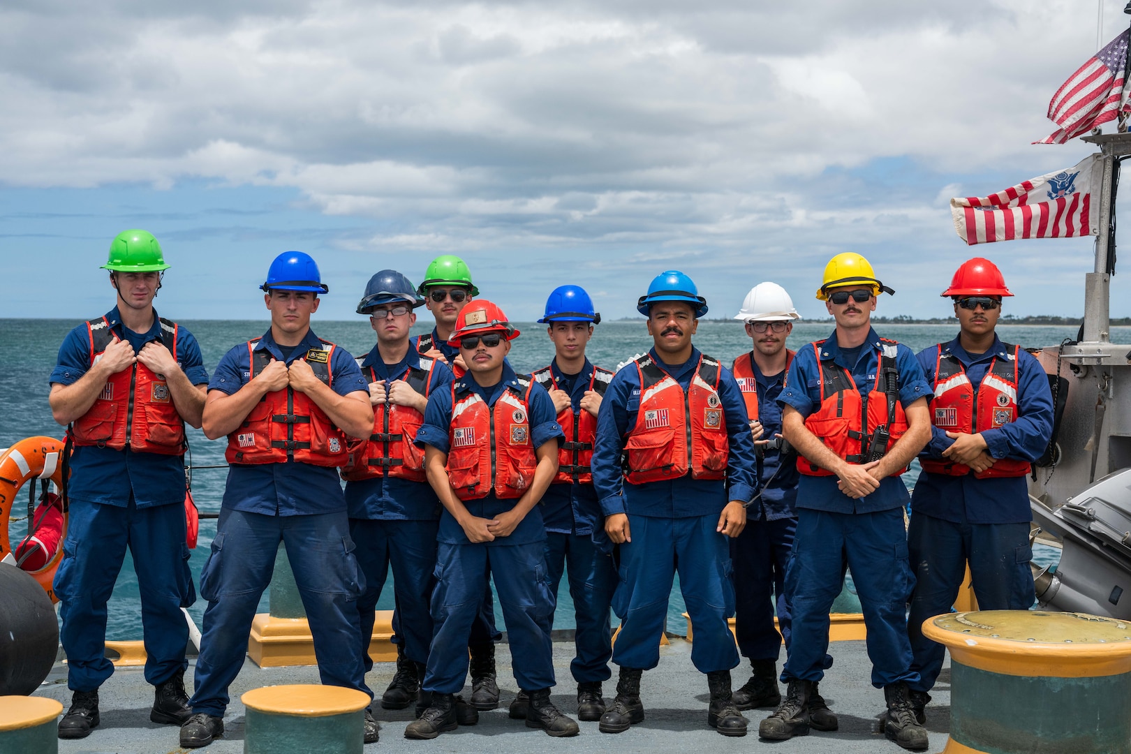 U.S. Coast Guardsmen assigned to medium endurance cutter USCGC Harriet Lane (WMEC 903) pose for a photo before preparing to moor the cutter on Joint Base Pearl Harbor-Hickam in Honolulu, Hawaii, July 9, 2025. The crew of the Harriet Lane patrolled over 15,000 nautical miles around the Hawaiian Islands, French Polynesia, Cook Islands, and American Samoa. (U.S. Coast Guard photo by Petty Officer 3rd Class Austin Wiley)