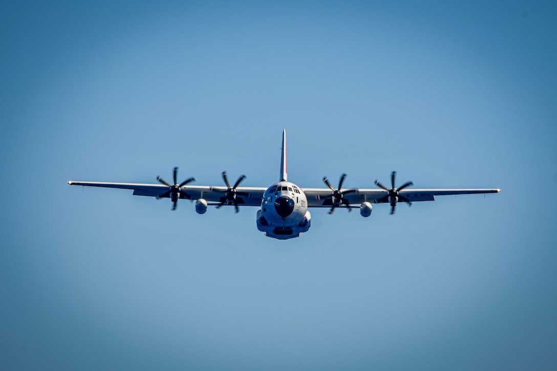 An HC-130 Hercules airplane crew assigned to U.S. Coast Guard Air Station Barbers Point in Kapolei, Hawaii, flies toward the medium endurance cutter USCGC Harriet Lane (WMEC 903) offshore French Polynesia June 2, 2025. The airplane crew delivered equipment to the cutter, assisting the crew during their Operation Blue Pacific patrol. (U.S. Coast Guard photo by Petty Officer 1st Class Kenneth Shellenberger)