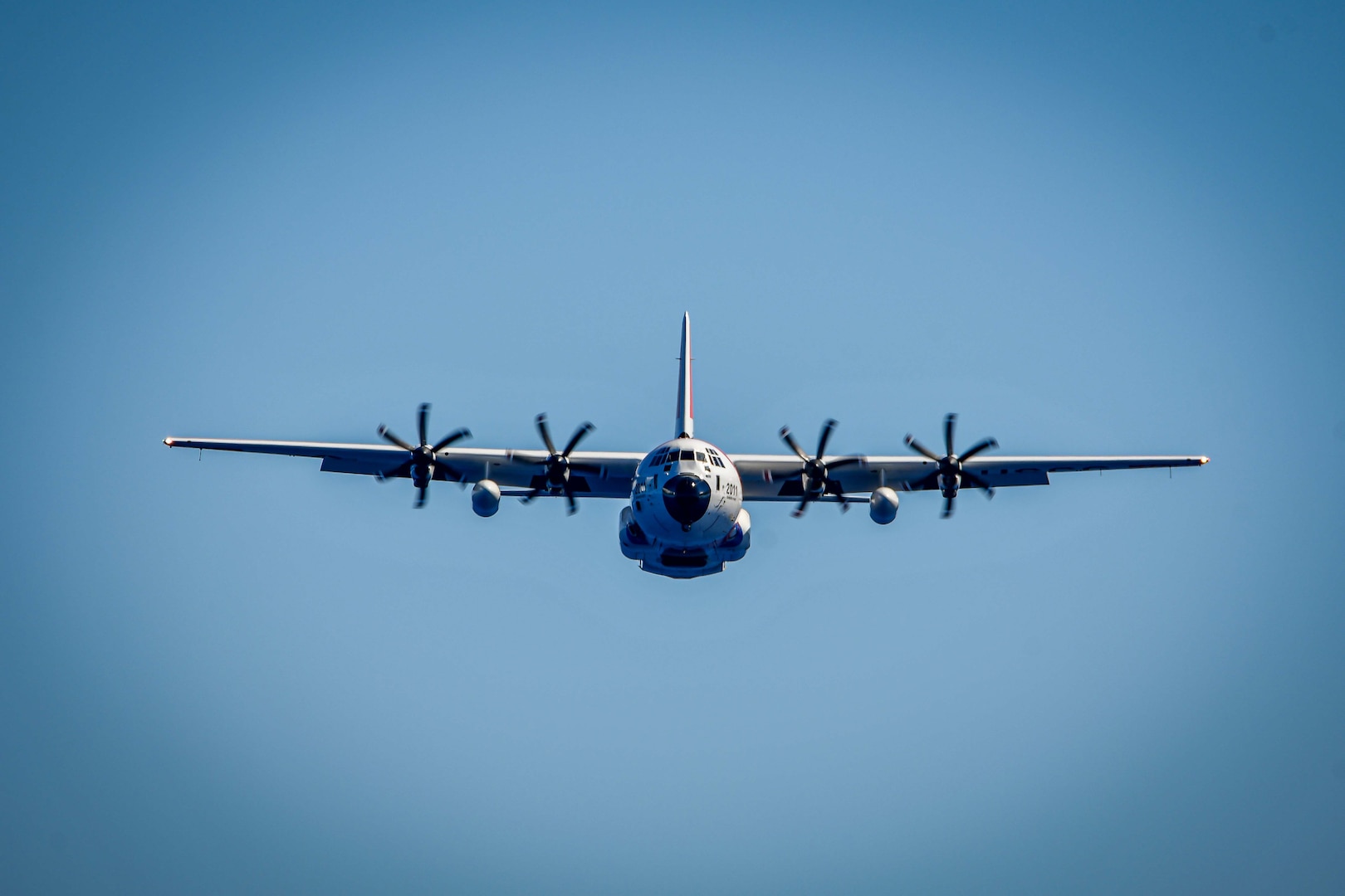 An HC-130 Hercules airplane crew assigned to U.S. Coast Guard Air Station Barbers Point in Kapolei, Hawaii, flies toward the medium endurance cutter USCGC Harriet Lane (WMEC 903) offshore French Polynesia June 2, 2025. The airplane crew delivered equipment to the cutter, assisting the crew during their Operation Blue Pacific patrol. (U.S. Coast Guard photo by Petty Officer 1st Class Kenneth Shellenberger)