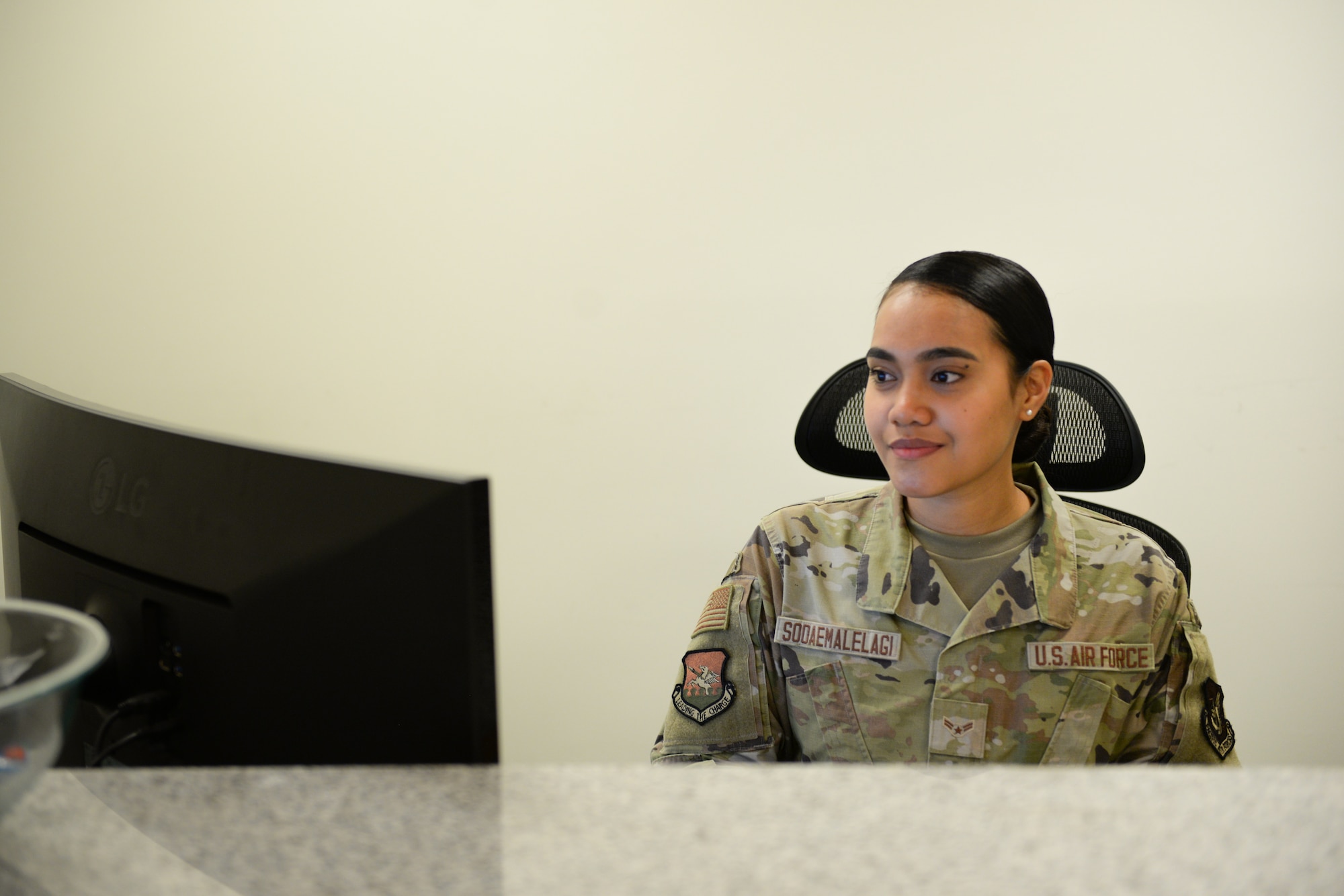 An Airman does administrative tasks on the computer.