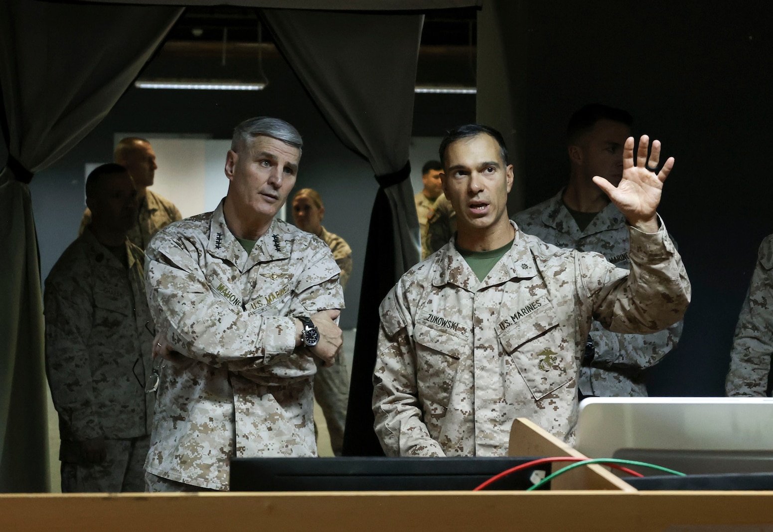 The 37th Assistant Commandant of the Marine Corps, Gen. Christopher J. Mahoney, left, receives a brief from Maj. Joshua Zukowski, an operations officer with Task Force 51/5th Marine Expeditionary Brigade, during a visit to Naval Support Activity Bahrain, May 22, 2025. Mahoney’s visit was part of a larger tour of U.S. Central Command and U.S. European Command areas of responsibility. (U.S. Marine Corps photo by Sgt. Angela Wilcox)