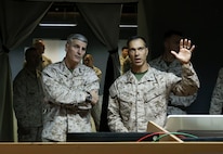 The 37th Assistant Commandant of the Marine Corps, Gen. Christopher J. Mahoney, left, receives a brief from Maj. Joshua Zukowski, an operations officer with Task Force 51/5th Marine Expeditionary Brigade, during a visit to Naval Support Activity Bahrain, May 22, 2025. Mahoney’s visit was part of a larger tour of U.S. Central Command and U.S. European Command areas of responsibility. (U.S. Marine Corps photo by Sgt. Angela Wilcox)