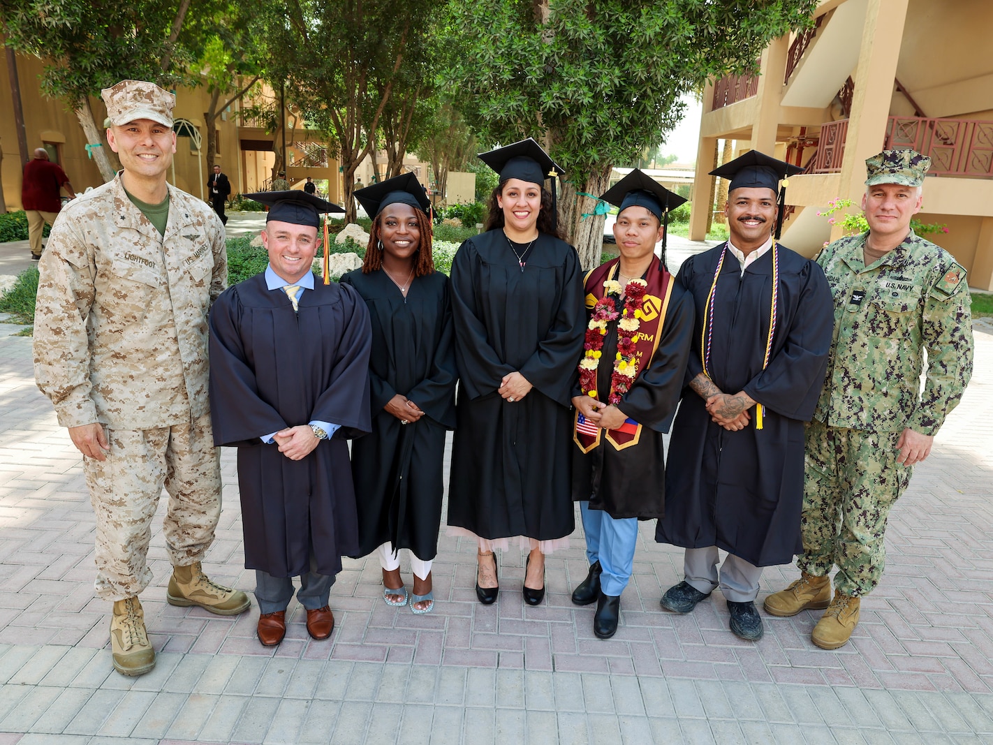 NAVAL SUPPORT ACTIVITY BAHRAIN (May 1, 2025) U.S. Marine Corps Brig. Gen. Stephen Lightfoot, left, the commanding general of Task Force 51/5th Marine Expeditionary Brigade, poses with Marines and Sailors assigned to TF 51/5th at their combined college graduation ceremony. (Official U.S. Marine Corps photo)