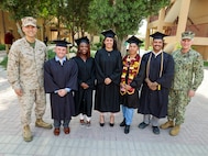 NAVAL SUPPORT ACTIVITY BAHRAIN (May 1, 2025) U.S. Marine Corps Brig. Gen. Stephen Lightfoot, left, the commanding general of Task Force 51/5th Marine Expeditionary Brigade, poses with Marines and Sailors assigned to TF 51/5th at their combined college graduation ceremony. (Official U.S. Marine Corps photo)