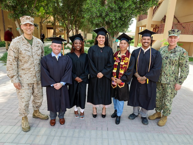 NAVAL SUPPORT ACTIVITY BAHRAIN (May 1, 2025) U.S. Marine Corps Brig. Gen. Stephen Lightfoot, left, the commanding general of Task Force 51/5th Marine Expeditionary Brigade, poses with Marines and Sailors assigned to TF 51/5th at their combined college graduation ceremony. (Official U.S. Marine Corps photo)