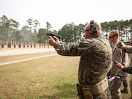 U.S. Marine Corps Col. Mark Liston, director of operations for Task Force 51/5th Marine Expeditionary Brigade, fires a M18 pistol from the 25-yard line during the Marine Corps Marksmanship Competition East (MCMC-E) on Stone Bay, Marine Corps Base Camp Lejeune, North Carolina, March 13, 2025. MCMC-E is an annual two-week event held at Weapons Training Battalion on Stone Bay, MCB Camp Lejeune, North Carolina, to improve Marines’ marksmanship, combat readiness, and weapon proficiency. (U.S. Marine Corps photo by Sgt. Angela Wilcox)