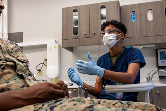 U.S. Navy Hospital Corpsman 3rd Class Robert McGill, a dental technician with 2nd Dental Battalion, 2nd Marine Logistics Group, and a native of Heidelberg, Mississippi, speaks to a patient during a checkup at Marine Corps Base Camp Lejeune, North Carolina, July 1, 2025. McGills Command selected him as Warrior of the Week For his unwavering commitment to mission readiness and excellence in patient care throughout 2nd MLG. Each week, 2nd MLG recognizes one outstanding Marine or Sailor that goes above and beyond in their duties and embodies the qualities of an outstanding service member. (U.S. Marine Corps Photo by Lance Cpl. Brady V. Hathaway)