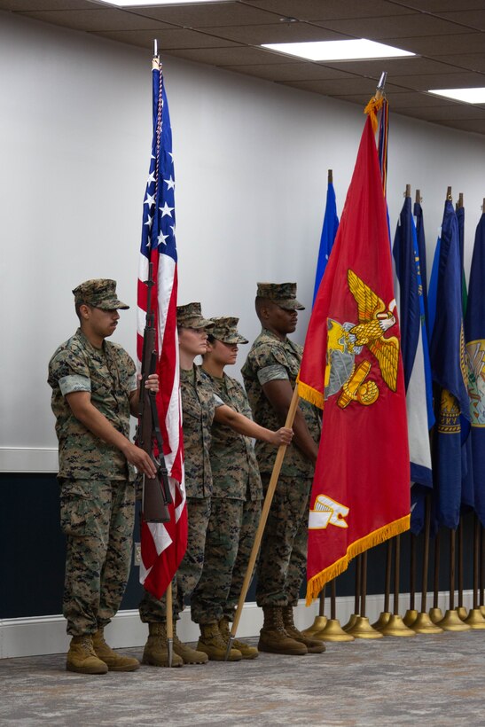 The color guard with 2nd Network Battalion, Marine Corps Cyberspace Operations Group, present the colors during the 2nd Network Battalion change of command ceremony at Tun Alley on Marine Corps Base Camp Lejeune, North Carolina, June 13, 2025. The change of command ceremony represents the passing of responsibility, authority and accountability from the outgoing commanding officer to the incoming commanding officer. (U.S. Marine Corps photo by Lance Cpl. Hunter Brock)
