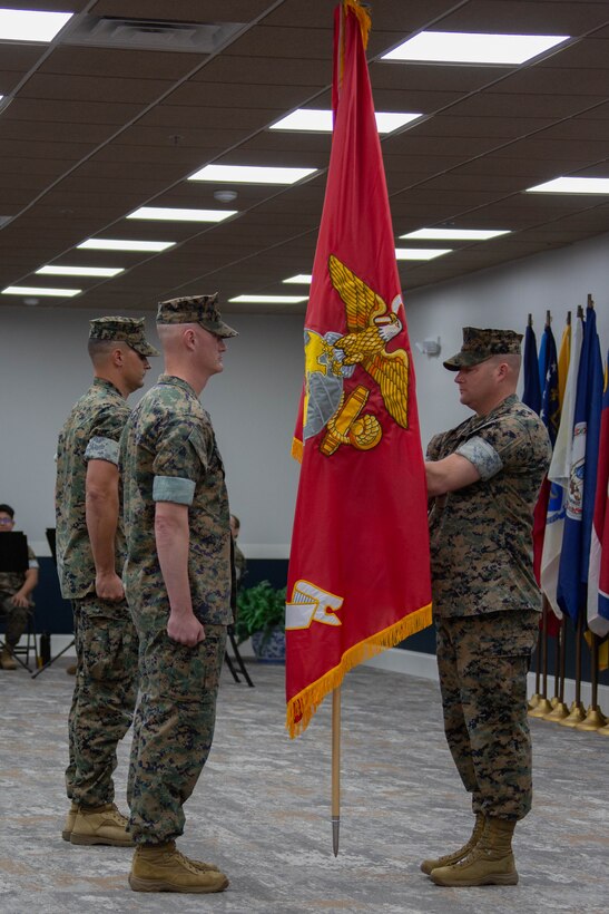 U.S. Marine Corps Sgt. Maj. Casey S. Chandler, right, passes the colors to Lt. Col. Andrew S. Walker, outgoing commanding officer, both with 2nd Network Battalion, Marine Corps Cyberspace Operations Group, during the 2nd Network Battalion change of command ceremony at Tun Alley on Marine Corps Base Camp Lejeune, North Carolina, June 13, 2025. The change of command ceremony represents the passing of responsibility, authority and accountability from the outgoing commanding officer to the incoming commanding officer. (U.S. Marine Corps photo by Lance Cpl. Hunter Brock)